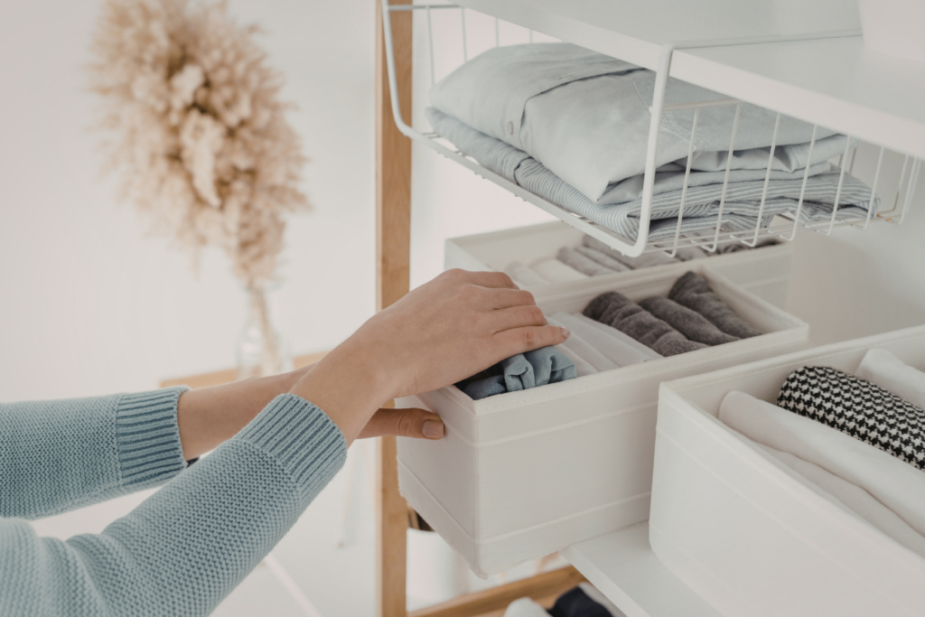 a person looking into a clothes organized storage